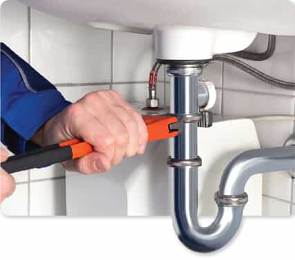 Plumber working on drain